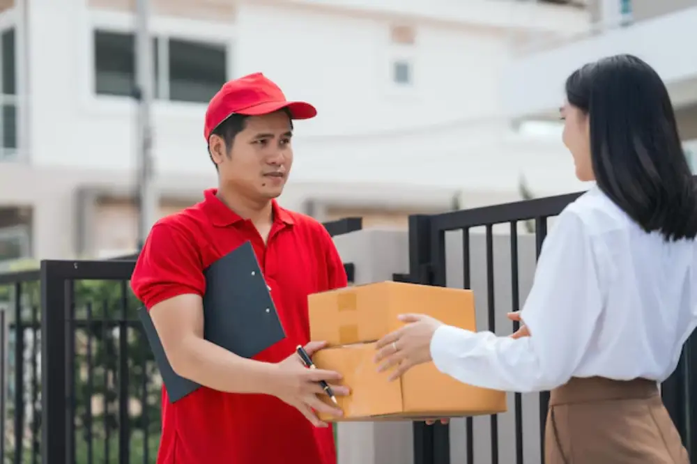Happy customer in Davao receiving a package through Jades Cargo Services Inc. logistics company door-to-door delivery.