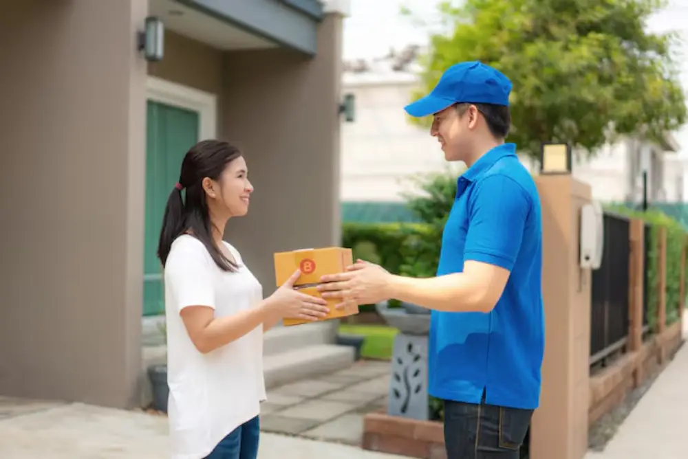 Happy customer in Davao receiving a package through Jades Cargo Services Inc. logistics company door-to-door delivery.
